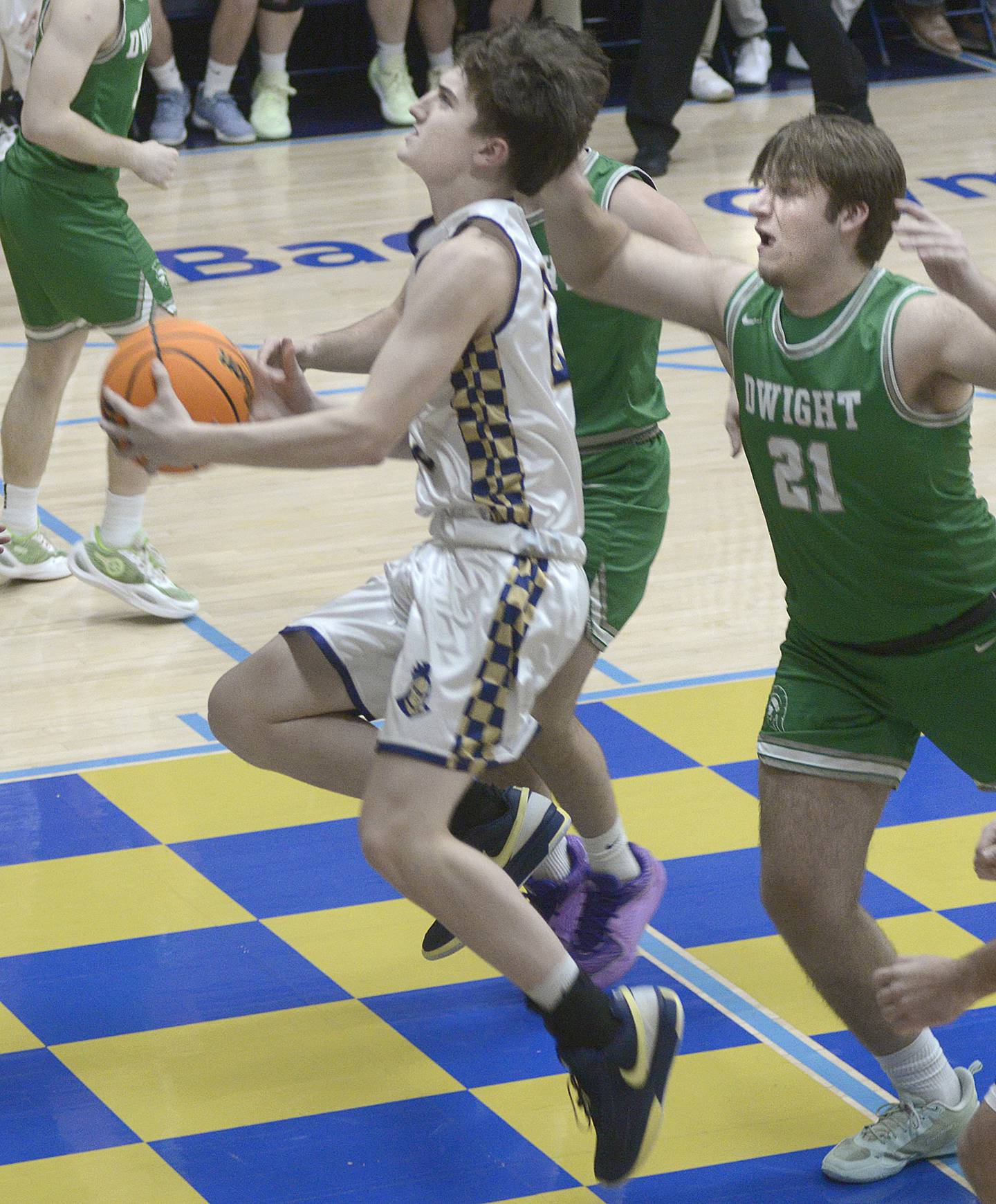 Marquette’s Griffin Dobberstein gets past Dwight’s Luke Gallent to begin a layup in the 1st period Monday at Marquette.