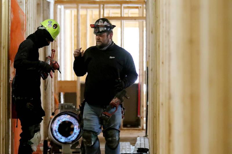 Kinnley Young, left, and Alex Borisenkov of Norman Mechanical in Elgin work on the third floor of the new Berkshire Johnsburg apartment building on Monday, Feb. 8, 2021 in Johnsburg.  The new Berkshire Johnsburg apartment building will have 68 total units, all of which qualify as affordable housing for seniors.