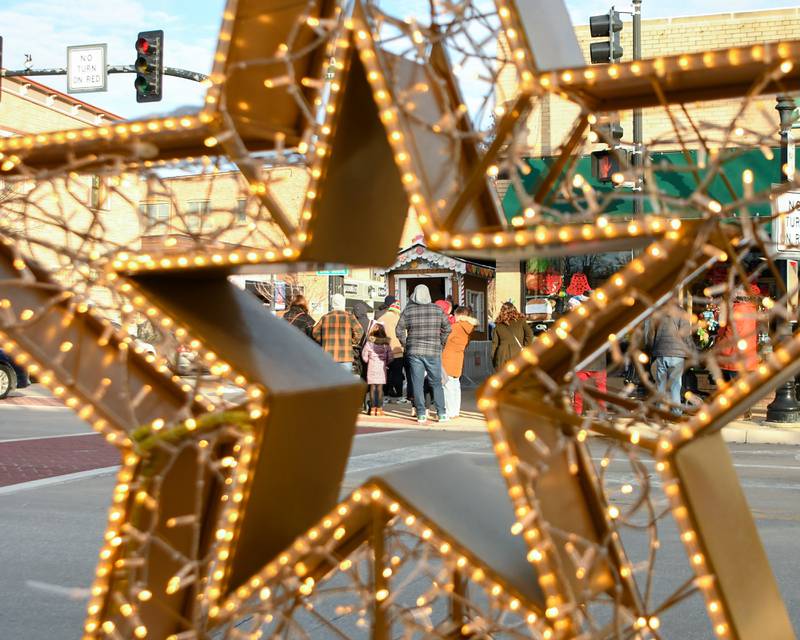 Guests wait to visit with Santa in his Gingerbread house on Saturday Dec. 21, 2024, held in downtown Downers Grove.