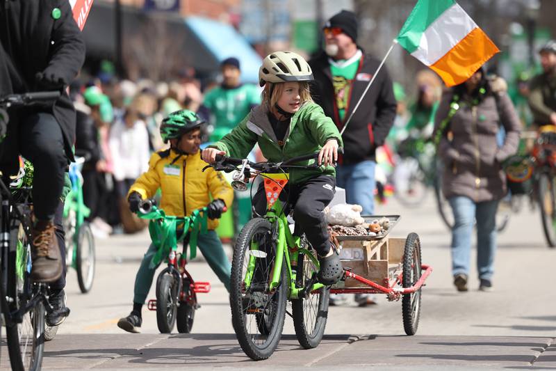 Kids ride their decorated bikes in the Plainfield Hometown Irish Parade on Sunday, March 17, 2024 in Plainfield.