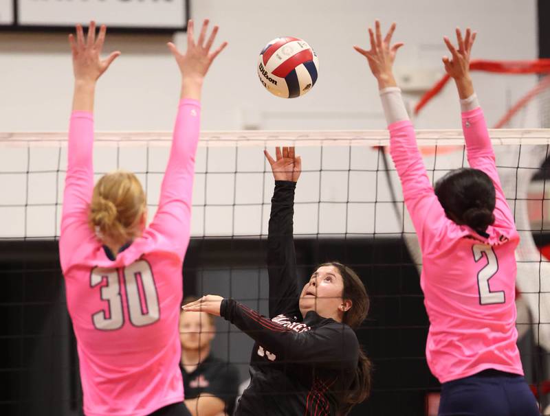 Indian Creek's Paloma Cardenas hits the ball between Hiawatha's Madison Krumwiede (left) and Nelly Delvalle during their match Tuesday, Oct. 15, 2024, at Indian Creek High School in Shabbona.