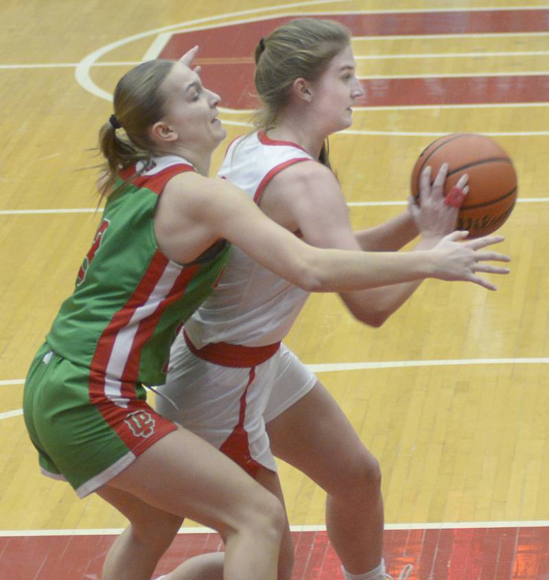LaSalle Peru’s Kaylee Abens works to work the ball free from Ottawa’s Hailey Larson Thursday during the 2nd period at Ottawa.