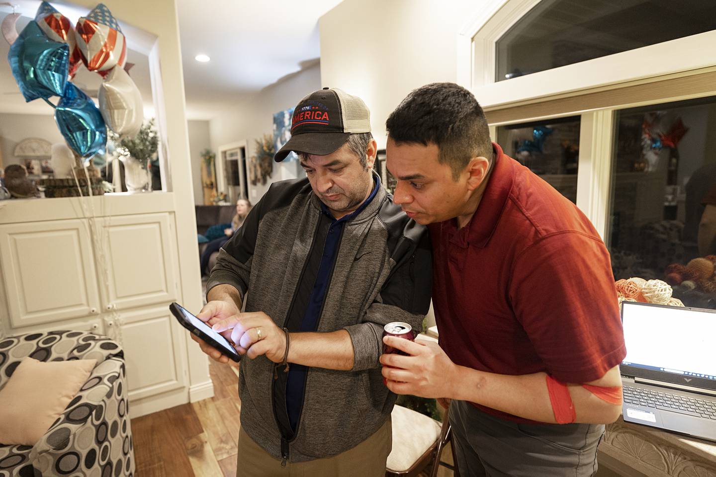 Liriam Mimini (left) shows Li Arellano the latest poll numbers Tuesday, March 19, 2024 for State Senate - 37th district GOP primary. Arellano is running against Chris Bishop and Tim Yager.