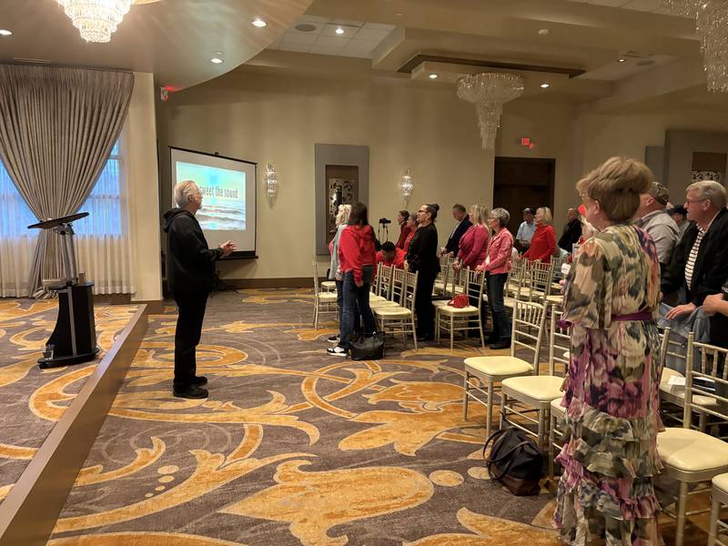 Attendees sing "Amazing Grace" during a MCGOPAC event in memory of Charlie Kirk Oct. 14, 2025.