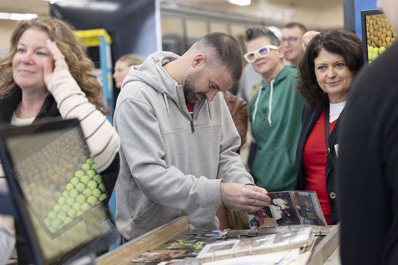 Friends, family and former employees of Oliver’s Corner Market visit and file through pictures Saturday, April 4, 2026, during a celebration of the Dixon grocery store. Owners Tim and Patty Oliver recently retired and sold the store after 39 years.