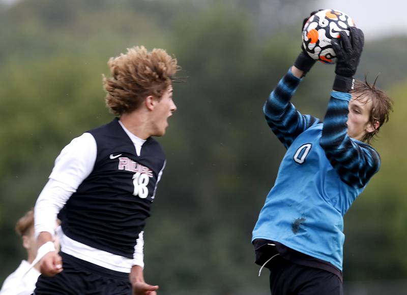 Prairie Ridge's Henry Knoll watches as Hampshire's Parker Smith grabs the ball during a Fox Valley Conference soccer match Tuesday, Sept. 19, 2023, at Prairie Ridge High School in Crystal Lake.