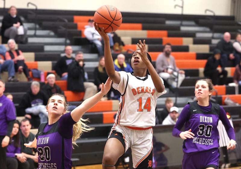 DeKalb’s Brytasia Long gets a layup between two Dixon defenders during their game Monday, Jan. 23, 2023, at DeKalb High School.