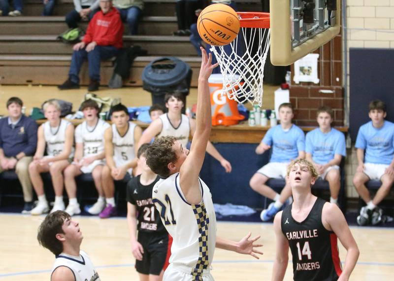 Marquette's Lucas Craig lets go of a shot underneath the hoop against Earlville on Friday, Jan. 3, 2025 in Bader Gym at Marquette High School.