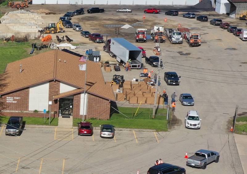 A long line of cars circle to drop off electronics during a free electronics recycling drive on Saturday, April 26, 2025 at the Bureau County Highway Department in Princeton.