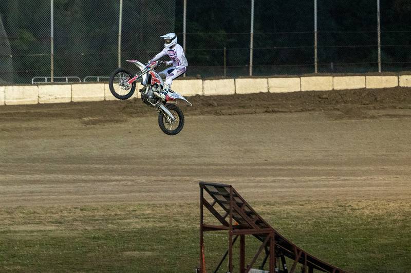 Alex Damlow flies Motocross bike over ramp during the FMX segment of the Monster Truck Bash show on Saturday, Sept. 13, 2025 at the La Salle Speedway in La Salle.