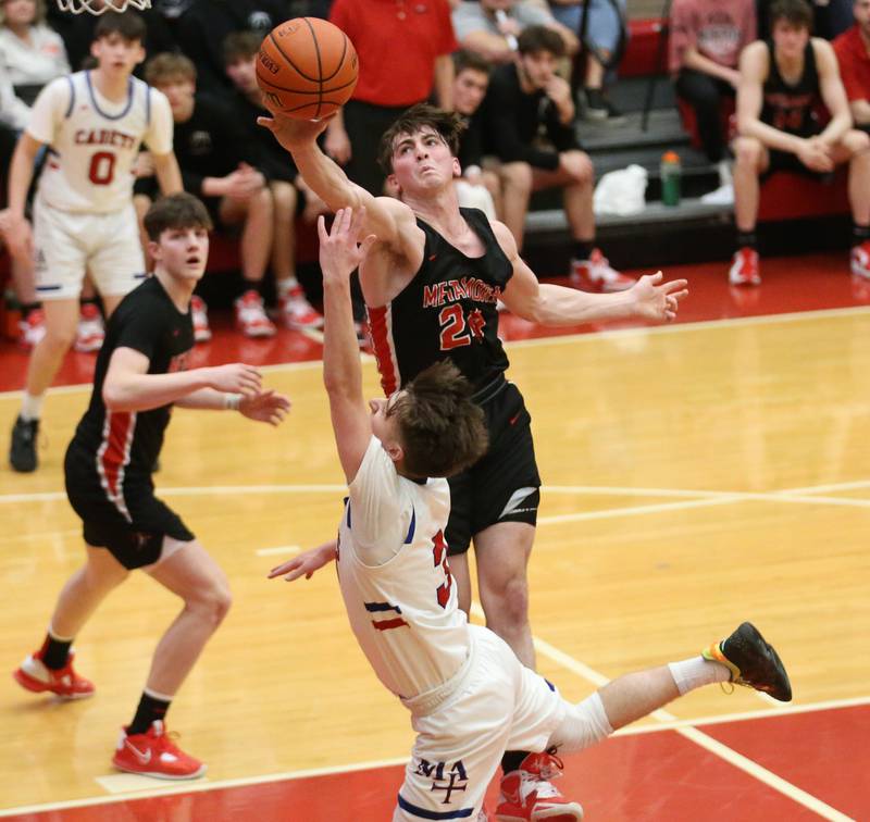 Metamora's Drew Tucker blocks Marmion's Collin Wainscott's shot under the hoop during the Class 3A Super-Sectional on Monday, March 6, 2023 at Ottawa High School.