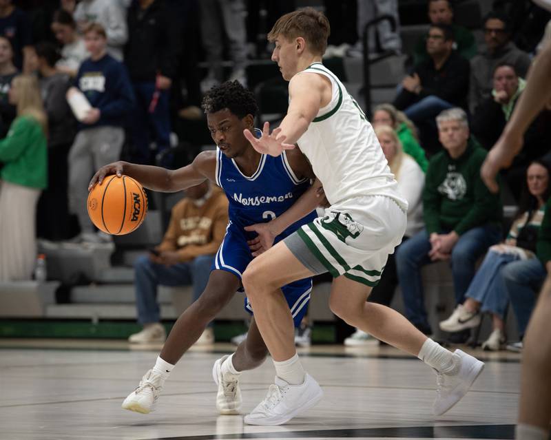 Newark's Reggie Chapman, left, controls the ball as Bishop McNamara's Coen Demack, right, guards in a game on Friday, Feb. 20, 2026.