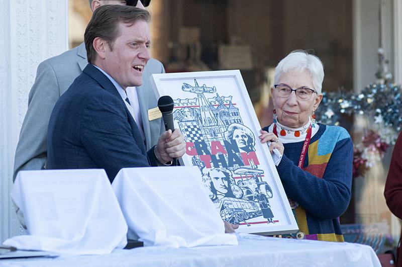 Joan Johnson, curator of the Ronald Reagan Birthplace museum in Tampico, accepts a poster from Graham Jeal, mayor of Margaret Thatcher's birth town Grantham, England during a visit Friday, Oct. 7, 2022.