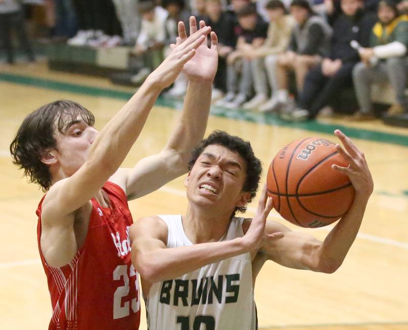 St. Bede's Isiah Hart (right) runs into Hall's Braden Curran (left) in the lane while failing to score on Monday, Dec. 14, 2022 at St. Bede Academy.