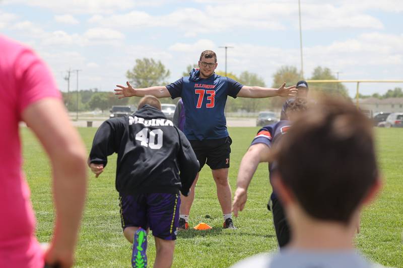 Josh Gesky, a former Manteno High School star and current offensive lineman at the University of Illinois, runs a drill with youth participants at his inaugural Youth O-Line Camp at Legacy Park in Manteno on Saturday, May 17, 2025.