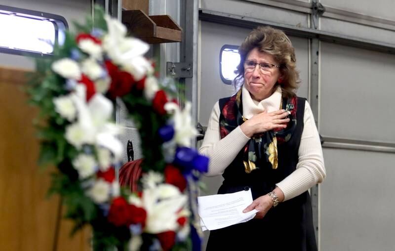 Mary Olczyk of Carol Stream touches her heart as she is overcome with emotion during a remembrance Saturday at Wonder Lake Fire Protection District Station 2 on the 40th anniversary of a midair military jet explosion that happened over the small, rural area northeast of Woodstock. Olczyk’s husband and 26 others lost their lives as the plane exploded midair at 9:11 p.m., its flaming pieces raining over a 2-mile area near Greenwood.
