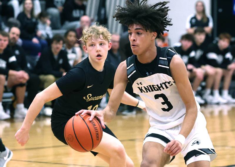 Kaneland's Evan Frieders drives by Sycamore's Isaiah Feuerbach during their game Friday, Jan. 5, 2024, at Kaneland High School in Maple Park.