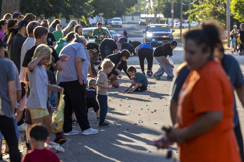 Kids scoop candy Thursday, Sept. 25, 2025, during Rock Falls’ homecoming parade.