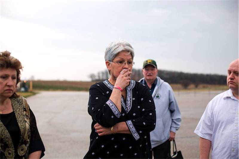Marlene Lantz (center) pays tribute to those who lost their life in a midair military plane explosion that killed 27 men and women March 19, 1982. Lantz was the chief deputy coroner of McHenry County at the time. Mary Olczyk (left), whose husband, Army Sgt. Stephen Olczyk, died in the crash, and Matt Marsh (right), who was 12 years old and lived in Woodstock in 1982, also pay tribute. Several years later, Marsh began doing research on the crash.
