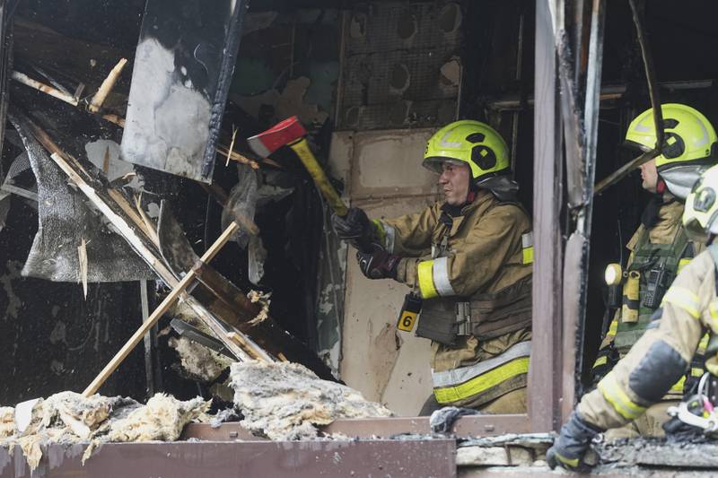 Firefighters work in a destroyed apartment building after a Russian attack in Kyiv, Ukraine, Monday, July 21, 2025. (AP Photo/Efrem Lukatsky)