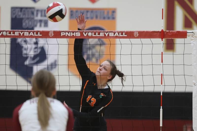 Plainfield East’s Ella Gierat hit a shot against Plainfield North on Thursday night.