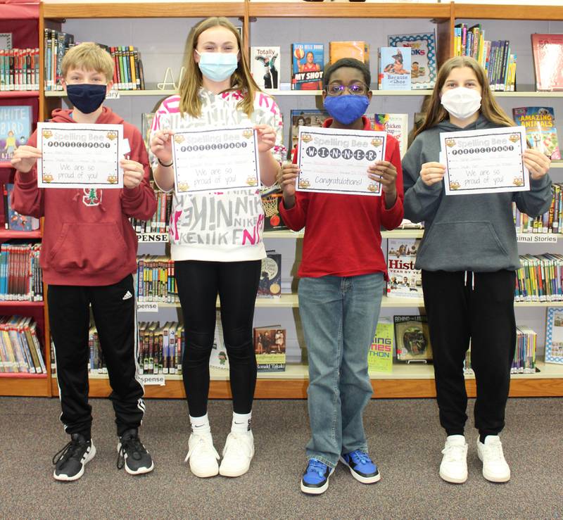 Drauden Point Middle School seventh grader Benjamin Adjei Jr. (second from right) took first place in his school's spelling bee and will compete in the 2022 Will County Regional Spelling Bee virtually in March. Seventh graders Adam De Boni and Lila Sipes (left to right) and sixth grader Kaelyn Zumdahl (far right) were runners up.  Adjei Jr. and six other District 202 middle school students will compete in the 2022 Will County Regional Spelling Bee virtually on Thursday, March 10, 2022.