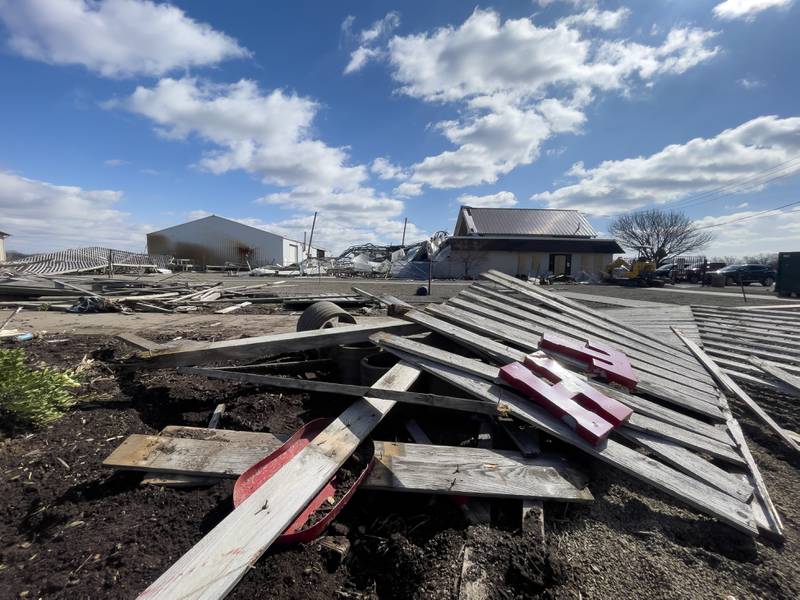 Letters from the Tholens' Landscape & Garden Center fence sign lay among the debris at the business along South Schuyler Avenue on March 13, 2026, following the March 10 tornado that caused widespread destruction in Kankakee County.
