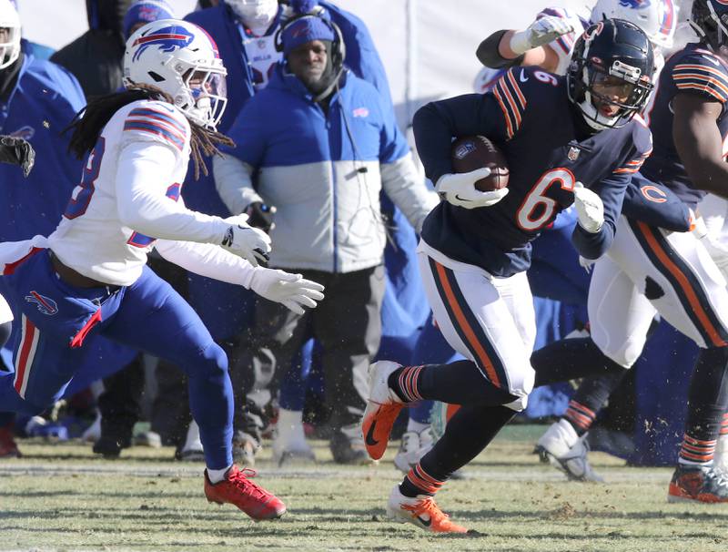 Chicago Bears cornerback Kyler Gordon carries the ball after intercepting a Buffalo Bills quarterback Josh Allen pass during their game Sunday, Dec. 24, 2022, at Soldier Field in Chicago.