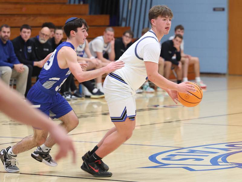 Hinckley-Big Rock's Austin Roop dribbles ahead of Rochelle Zell’s Toby Frankel during their game Tuesday, Dec. 17, 2024, at Hinckley-Big Rock High School.