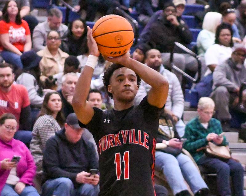 Yorkville's Christian Harrell (11) makes a three-point basket during the game on Friday Feb. 14, 2025, while traveling to take on Oswego East.