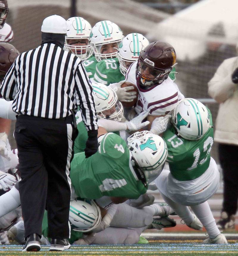 Loyola's Johnny McGuire (33) is wrapped up by a host of York Players during the IHSA Class 8A semifinal football game Saturday November 19, 2022 in Elmhurst.