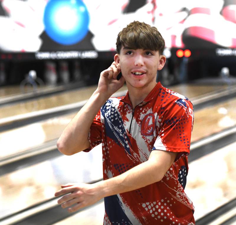 Oregon's Ethan Rowe smiles after throwing a strike during a match with Harvard at Town & Country Lanes in Mt. Morris on Friday, Dec. 19, 2025.