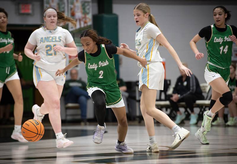 Bishop McNamara's Hailey Jackson, center, looks to recover a loose ball over Joliet Catholic's Emma Napier, center right, during the Class 2A Regional Championship on Thursday, Feb. 19, 2026.