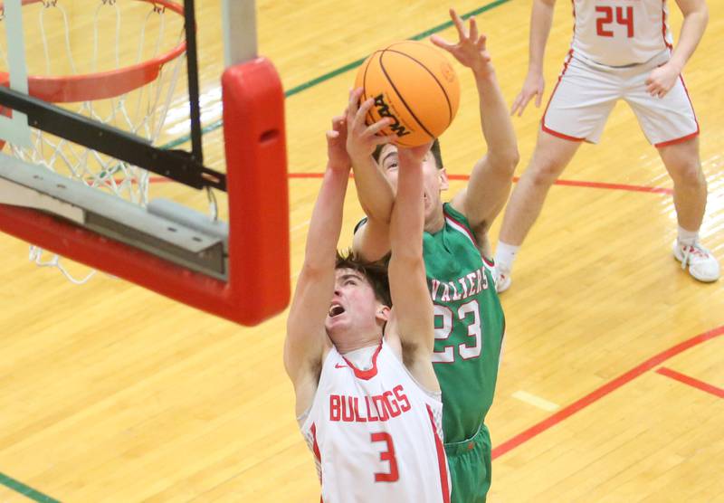 Streator's Nolan Ketcham grabs a rebond ahead of L-P's Nick Olivero during the Class 3A Regional title game on Friday, Feb. 28, 2025 in Sellett Gymnasium at L-P High School.