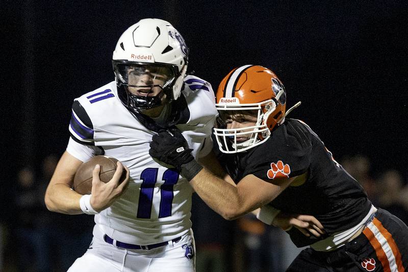 Dixon’s Jagger Kemp is pulled down by Byron’s Dawson Criddle Friday, Sept. 5, 2025, at Byron High School.