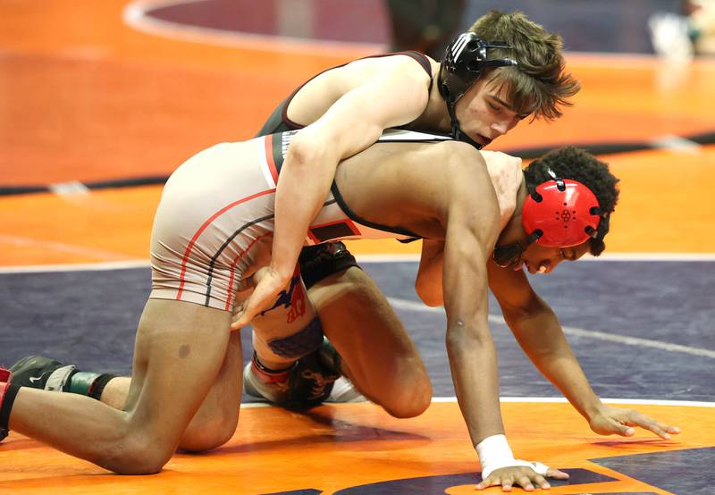 Prairie Ridge’s Tyler Evans controls Bremens’ Nore Turner during the Class 2A 120 pound 3rd place match in the IHSA individual state wrestling finals in the State Farm Center at the University of Illinois in Champaign.