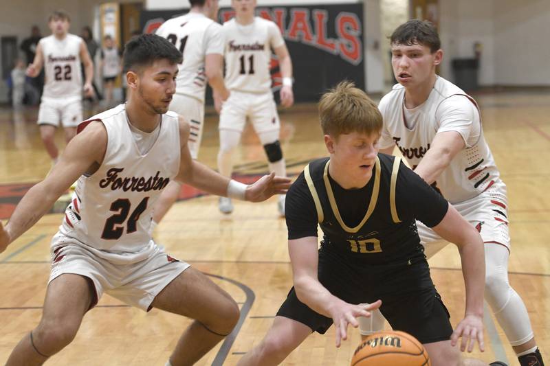 Forreston's Mickey Probst (24) and Kendall Erdmann (13) try and trap Pecatonica's Cooper Hamilton on Wednesday, Feb. 11, 2026.