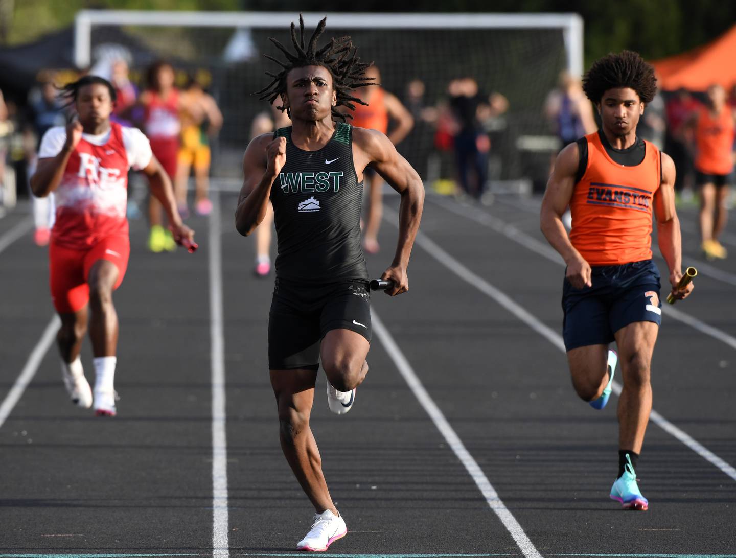 Glenbard West’s Jordan Ademuyiwa sprints for the finish line as the Hilltoppers win the 400-meter relay during the Red Grange boys track and field meet at Wheaton Warrenville South High School on Friday, April 24, 2026 in Wheaton.