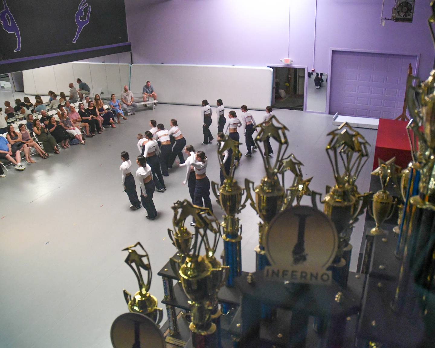 Trophy’s sit on a leg as dancers of the Beth Fowler School of Dance preform during the 40 year anniversary open house held on Saturday June 15, 2024, in St. Charles.