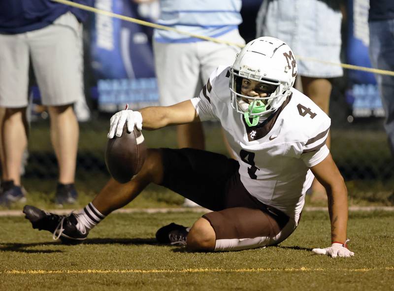 Mt. Carmel's Quentin Burrell (4) gets up smiling after scoring a touchdwon during the varsity football game between Mt. Carmel high school and Nazareth Academy on Friday, Sept. 12, 2025 in La Grange Park, IL.