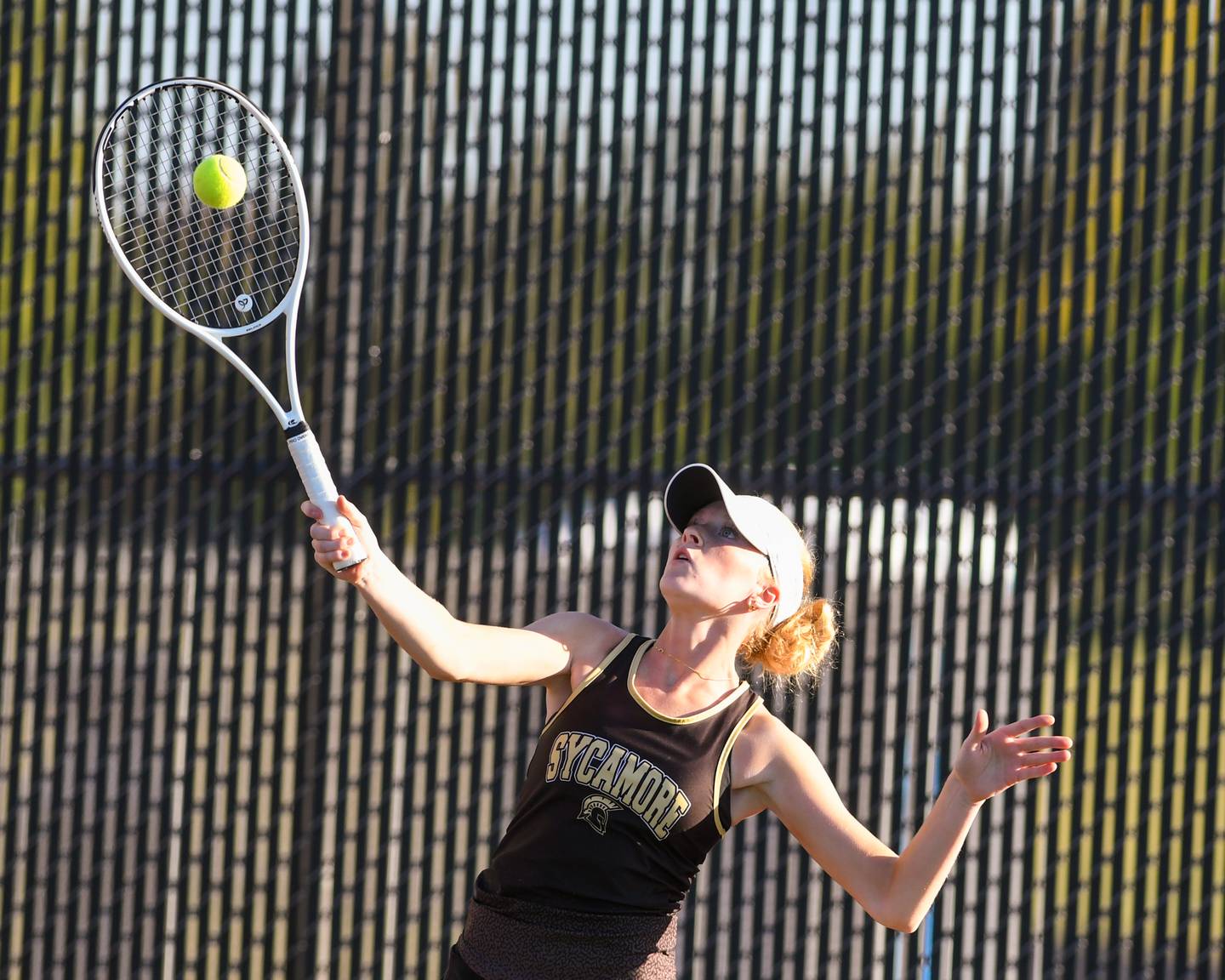 Reese Becker of Sycamore serves the ball onk during the first doubles match Thursday Sept. 25, 2025, while traveling to take on DeKalb High School.