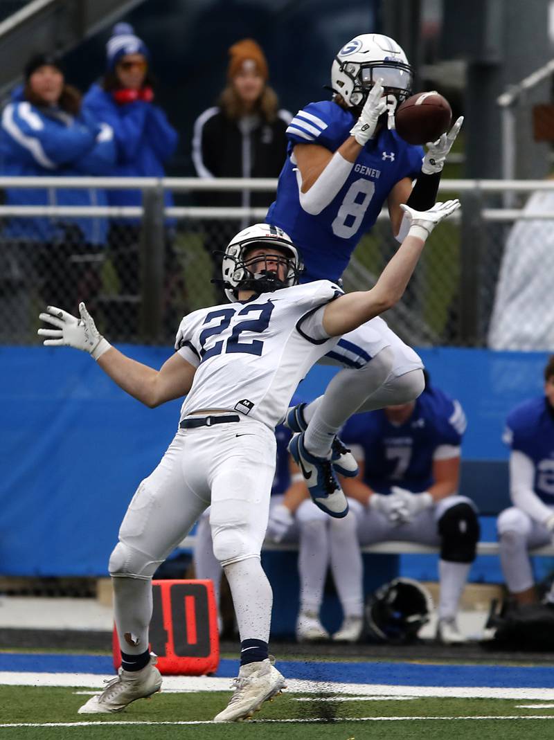 Geneva's Finnegan Weppner catches the ball over the defense of Cary-Grove's Michael Dunkin during an IHSA Class 6A semifinal football game on Saturday, Nov. 23, 2024, at Geneva High School.