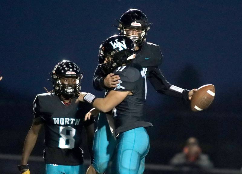Woodstock North’s Parker Halihan, top, is greeted in the end zone after a touchdown against Freeport in first-round IHSA Playoff football action on Saturday, Nov. 2, 2024 at Woodstock North High School in Woodstock.