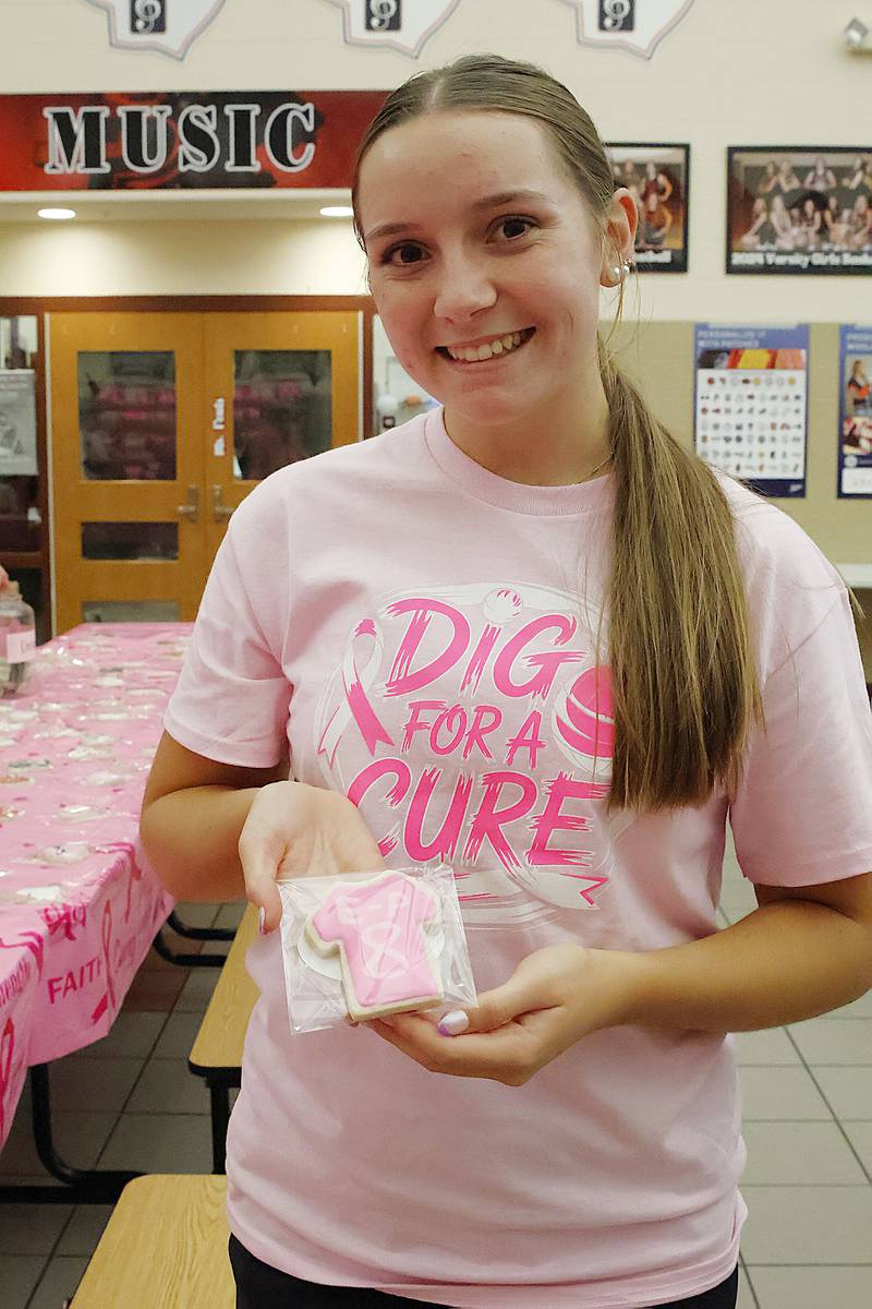 EP Senior volleyball player, Savannah Wuebben shows off one of the cookies she decorated for the bake sale for the Tuesday, Oct. 7, 2025, Dig for a Cure event in Prophetstown. The entire volleyball team decorated the cookies to be sold by donation with all funds going to CGH Women's Health Services.