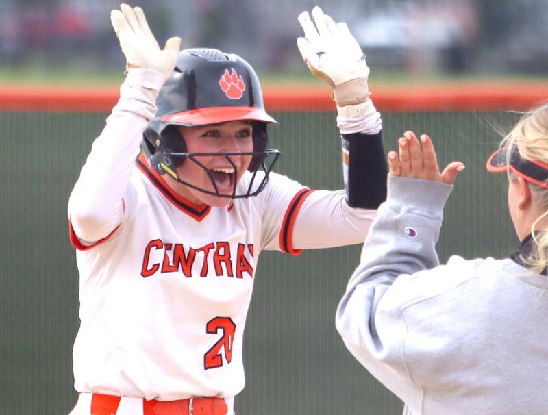 Crystal Lake Central’s Kate Show is greeted at first base on a single against Harvard in varsity softball at Crystal Lake Central High School in Crystal Lake on Monday, May 19, 2025.