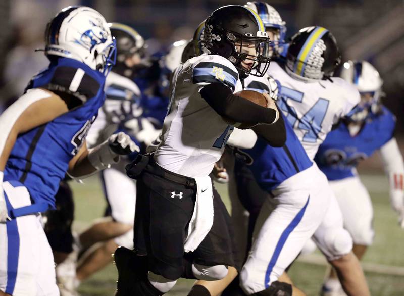 Maine West’s Thomas Delaney (15) looks for running room Friday October 28, 2022 in St. Charles.