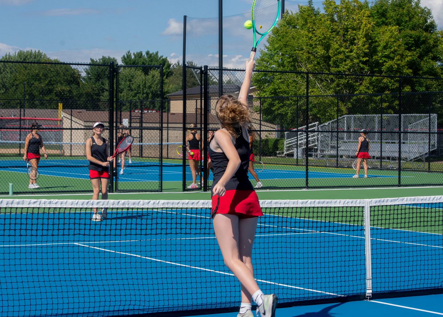 Yorkville High School girls tennis warms up before their opening match of the season on Aug. 26. The girls program has expanded to 15 girls on varsity and 17 on junior varsity.