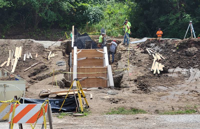 Workmen lay the groundwork for a new concrete staircase leading to the top of Ottawa's revovated Allen Park.