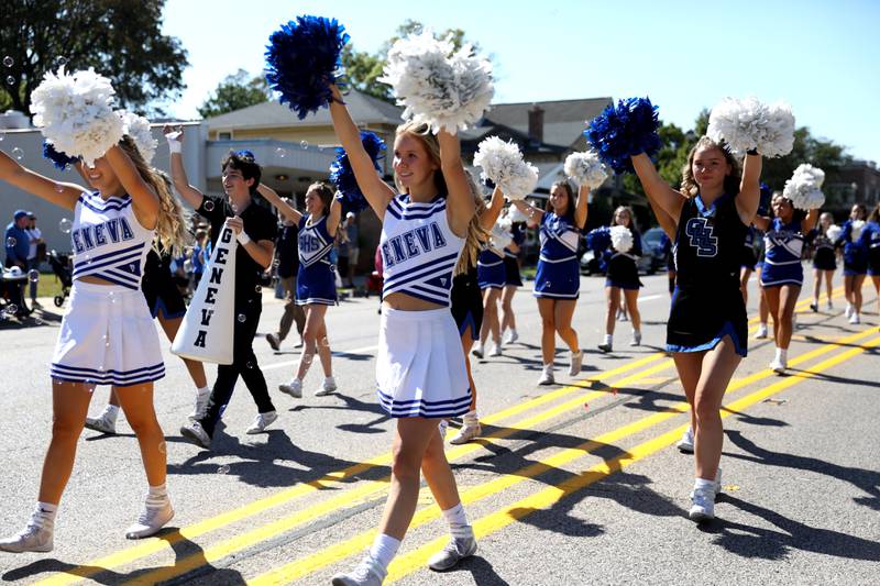 Geneva High School cheerleaders walk down State Street during the school’s annual homecoming parade on Friday, Sept. 15, 2023.