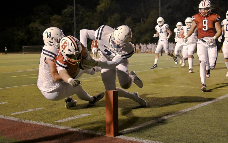Benet Academy’s Martin Radgowski is forced out of bounds by Saint Viator’s Allistar Kanyuh and Michael Tauscher at the 1-yard line in a football game at Benedictine University in Lisle on Friday, Sept. 20, 2024.